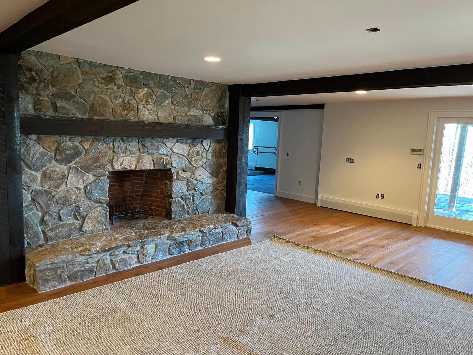 Finished stone fireplace and wood floor renovation